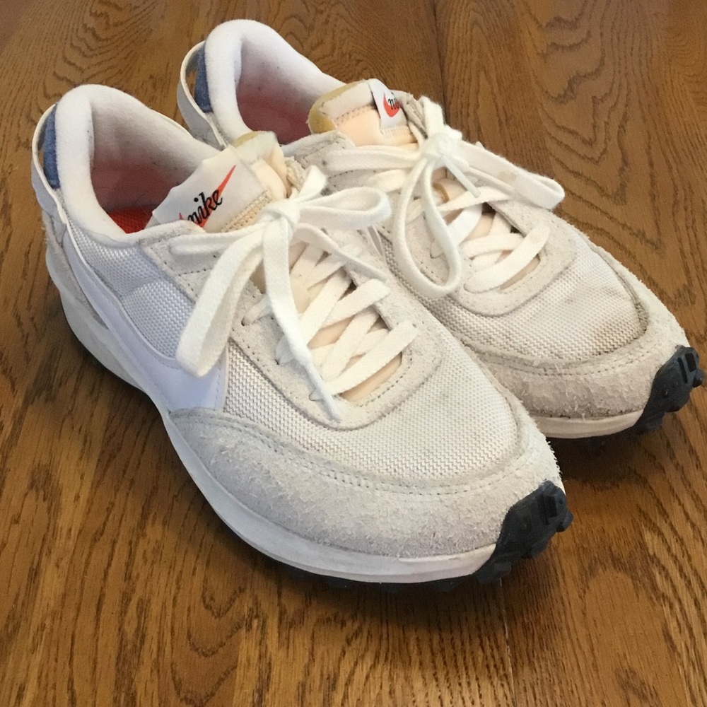 Woman’s Nike white fabric/leather sneaker. Size 7. Gently worn. White laces.